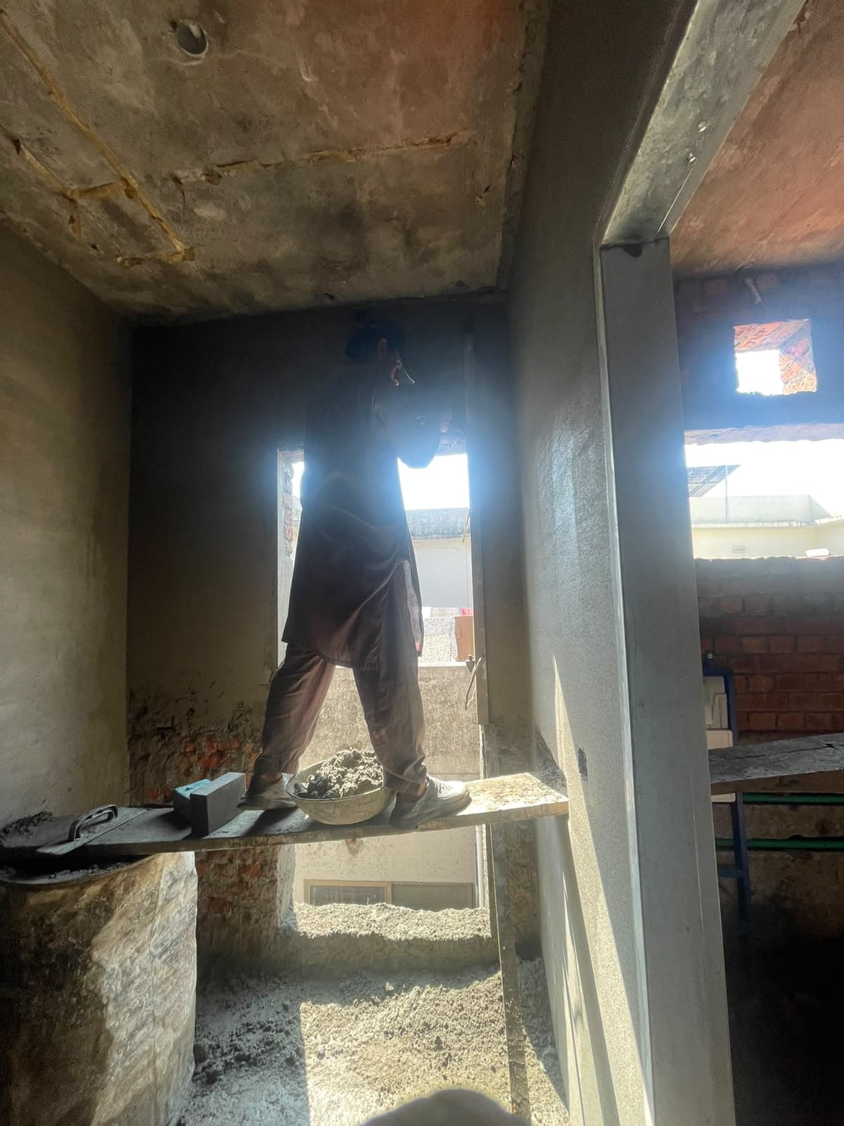 A new opening cut through, with the worker standing on a plank across it