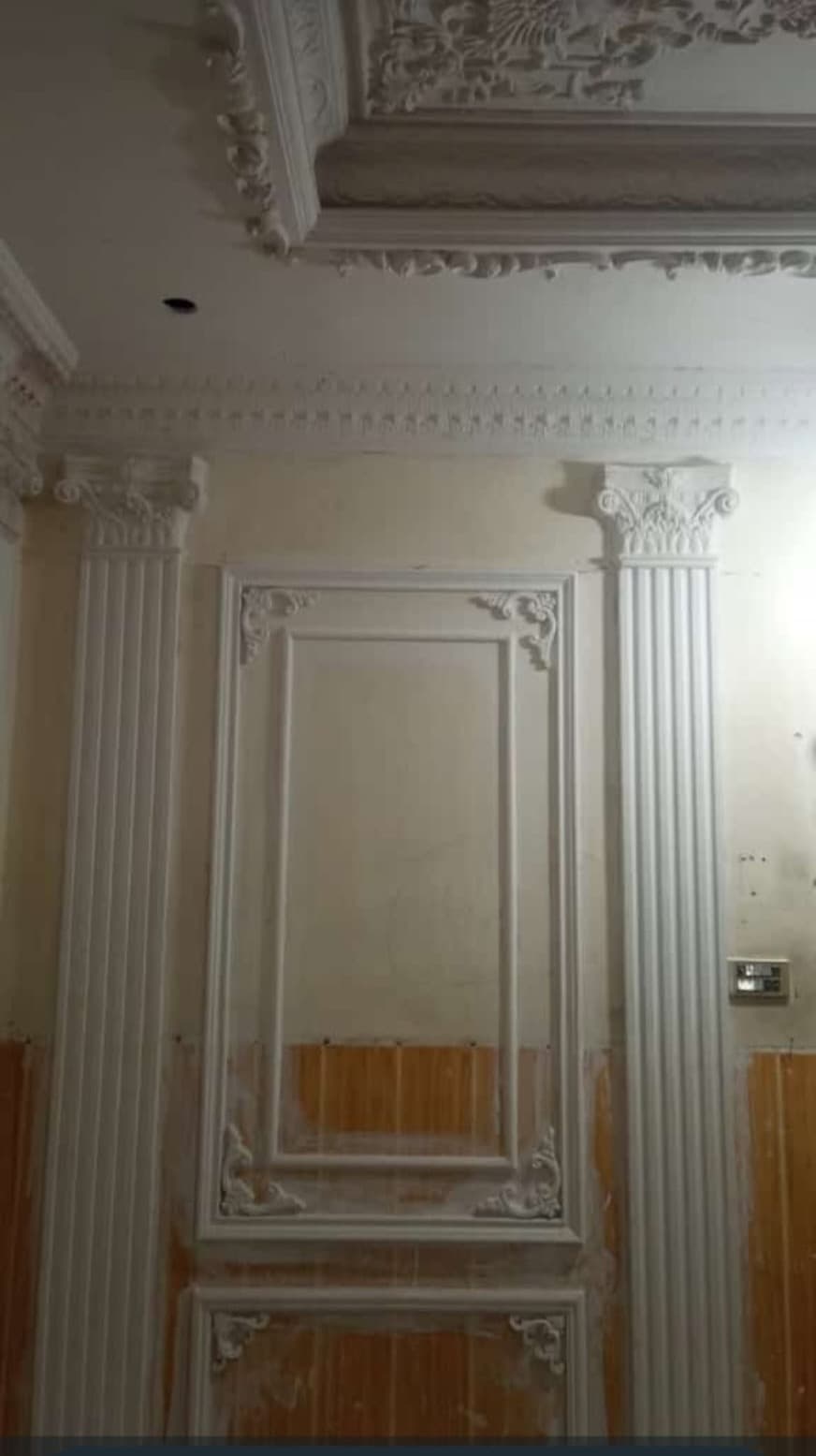 A worker beside a fluted wall panel, newly fitted