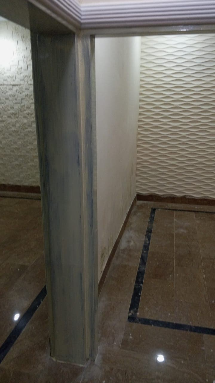 A doorway lined with wave-pattern 3D wall panels