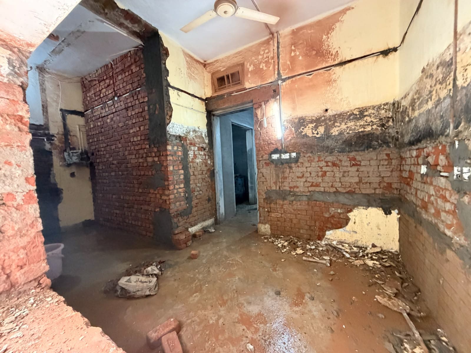 A room stripped back to brick, with new openings and doorways
