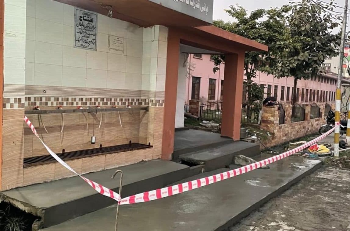 New concrete floor and steps in front of the water filtration plant taps, taped off to cure