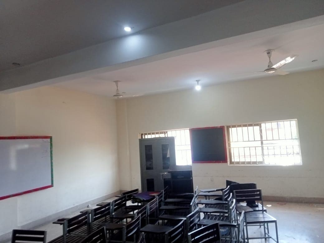 A finished classroom with clean cream walls, desks and boards